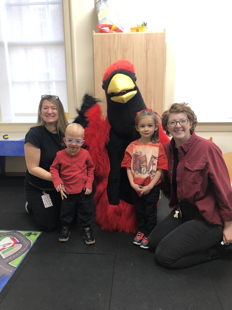 Pre-k students, teacher, and intervener pose for a picture with the cardinal mascot