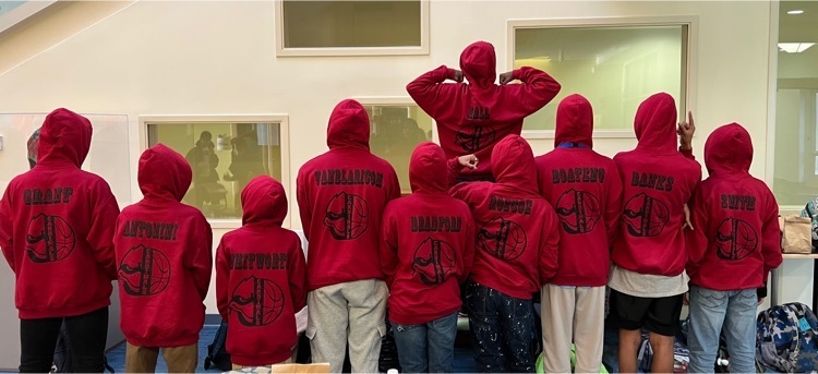 boys basketball team showing off the backs of their team sweatshirts