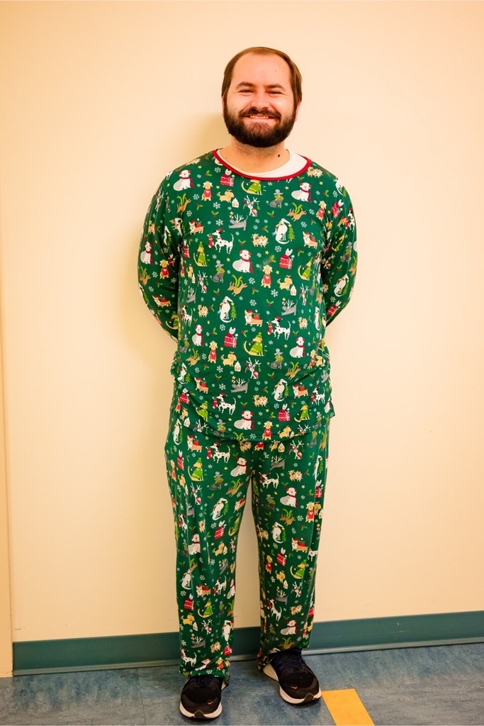 male teacher smiles wearing his Christmas pajamas 