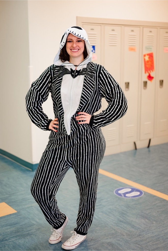 female staff wearing a Jack skellington outfit standing in a hallway 
