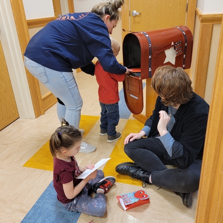 pre-K students getting cards from the mailbox and looking at them