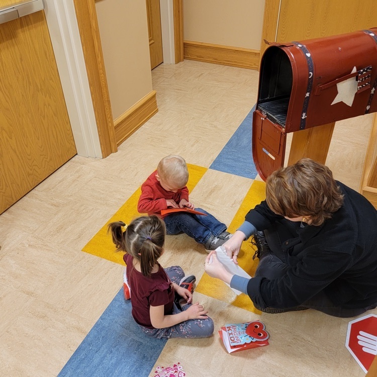 pre-K students looking at valentines cards