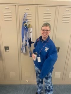 female student standing by her decorated locker 