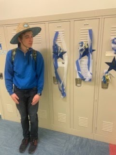 male student standing near his decorated locker