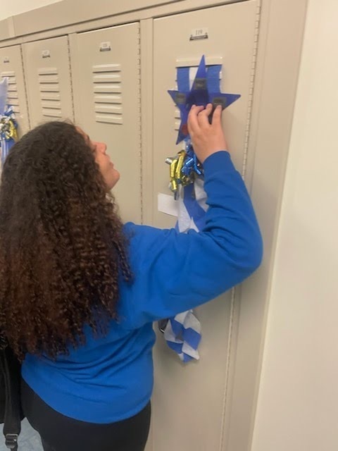 female student feeling the decorations on her locker 