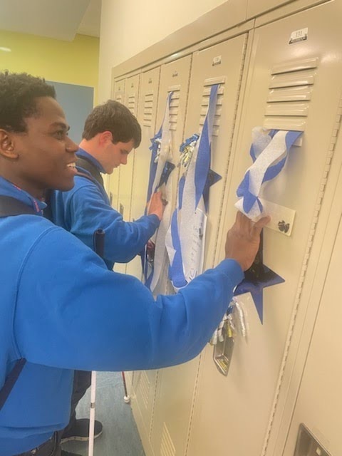 two male students feeling the decorations on their lockers