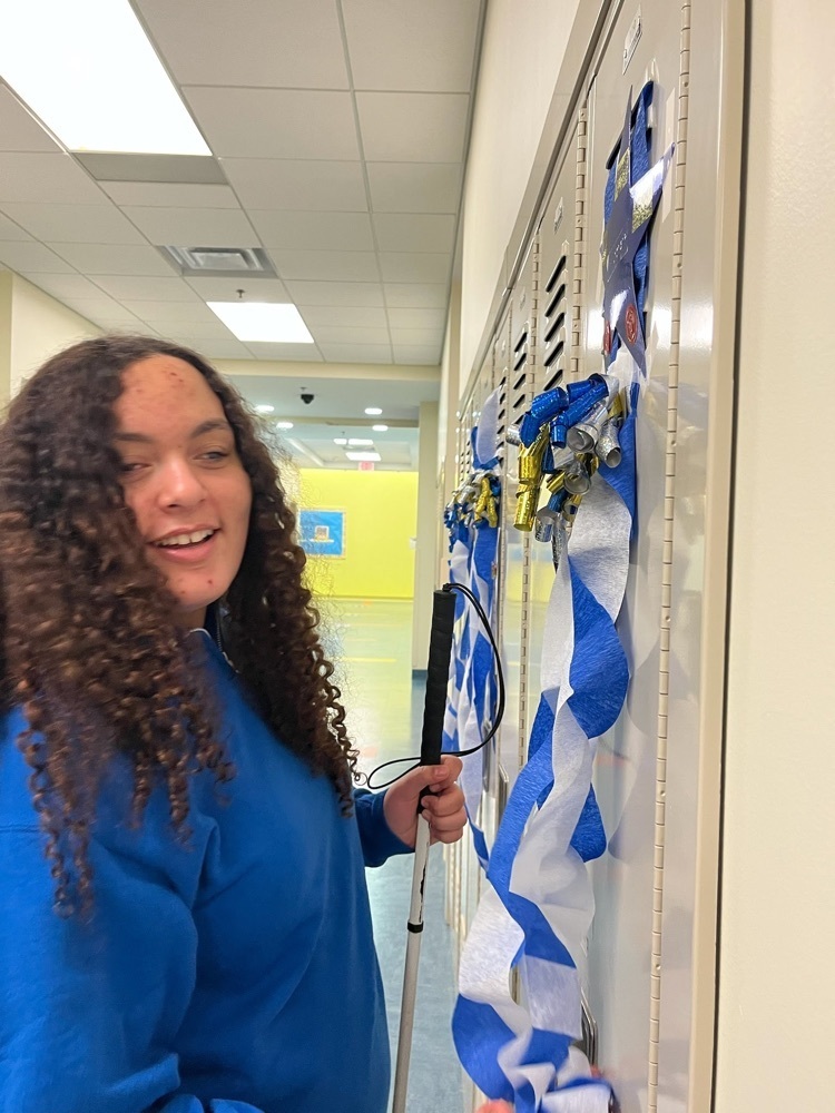 female student smiling after feeling the decorations on her locker