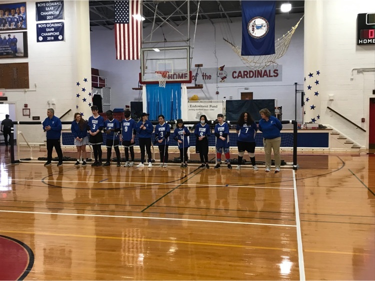 goalball teams and coaches lined up in front of the goal