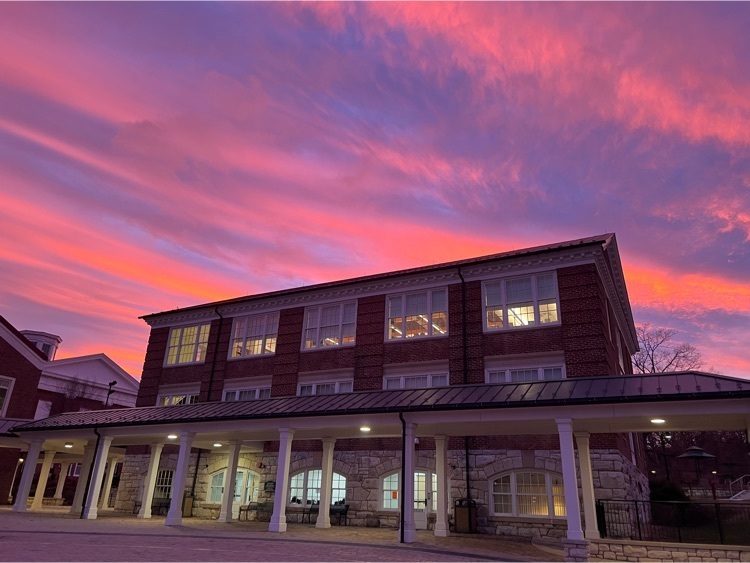 vsdb building with a purple and pink sunset sky above it 