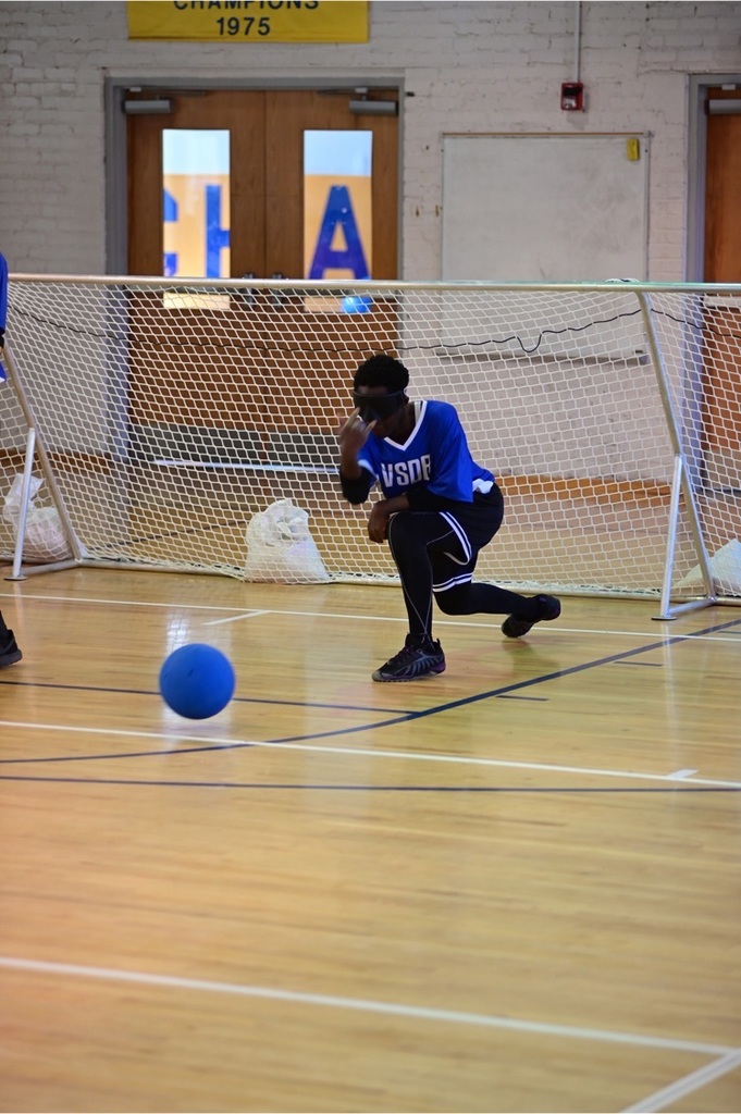 male Goalball player throwing the ball