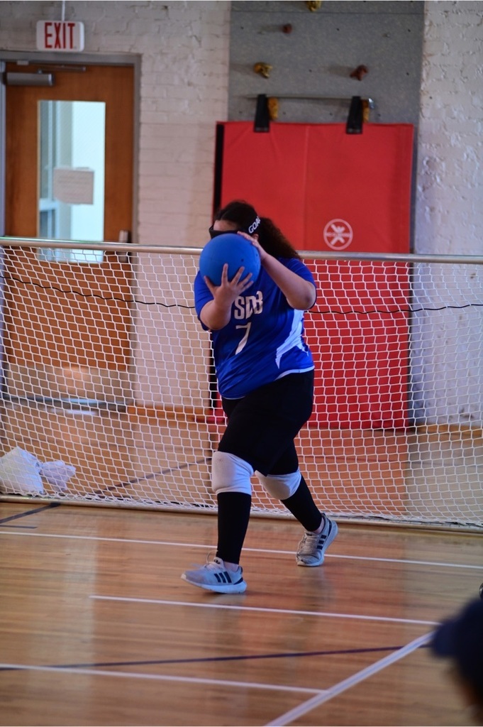 female Goalball player throwing the ball 