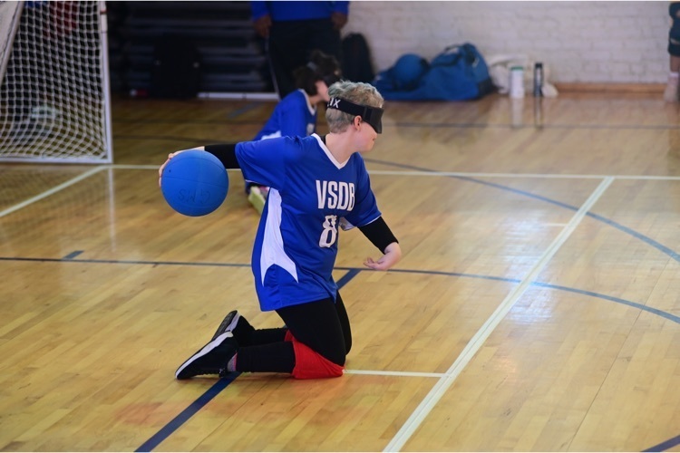 female Goalball player throwing the ball
