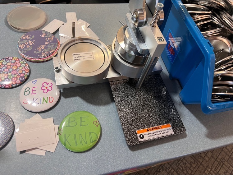 button maker with supplies near it 