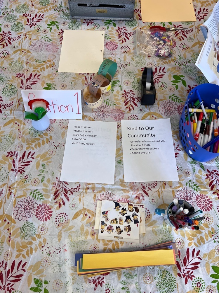 paper reads: station 1 - kind to our community. write or Braille something you love about vsdb, decorate with stickers, and add it to our chain