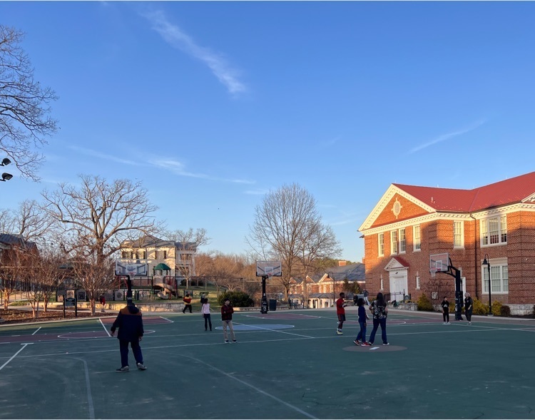 students playing kickball on the courtyard