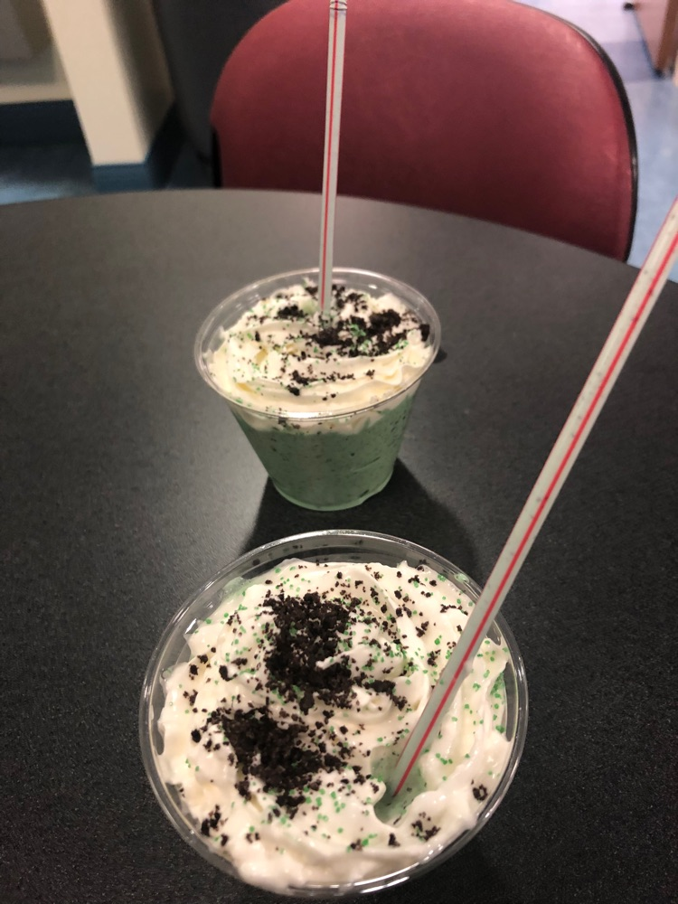 two shamrock shakes sitting on a table 