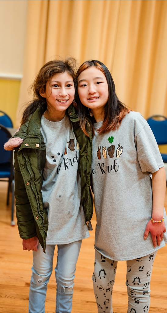 two female students standing together and smiling