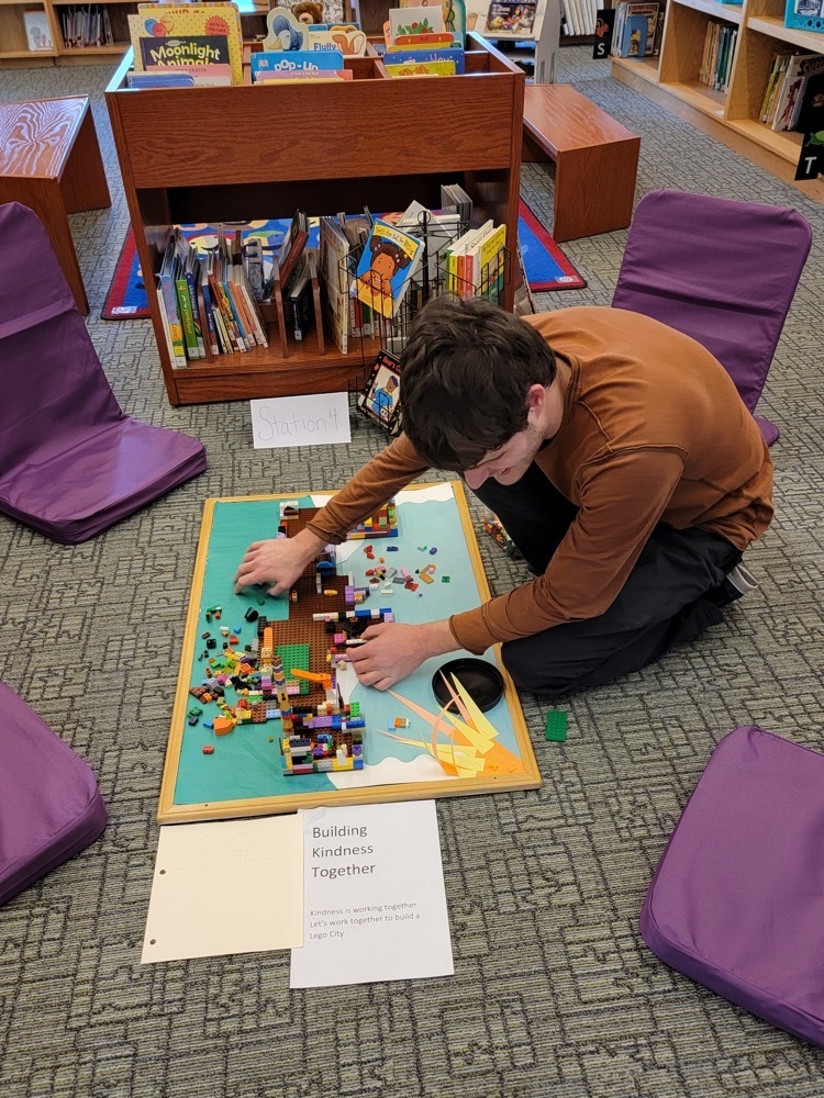 one male student building with Lego bricks 