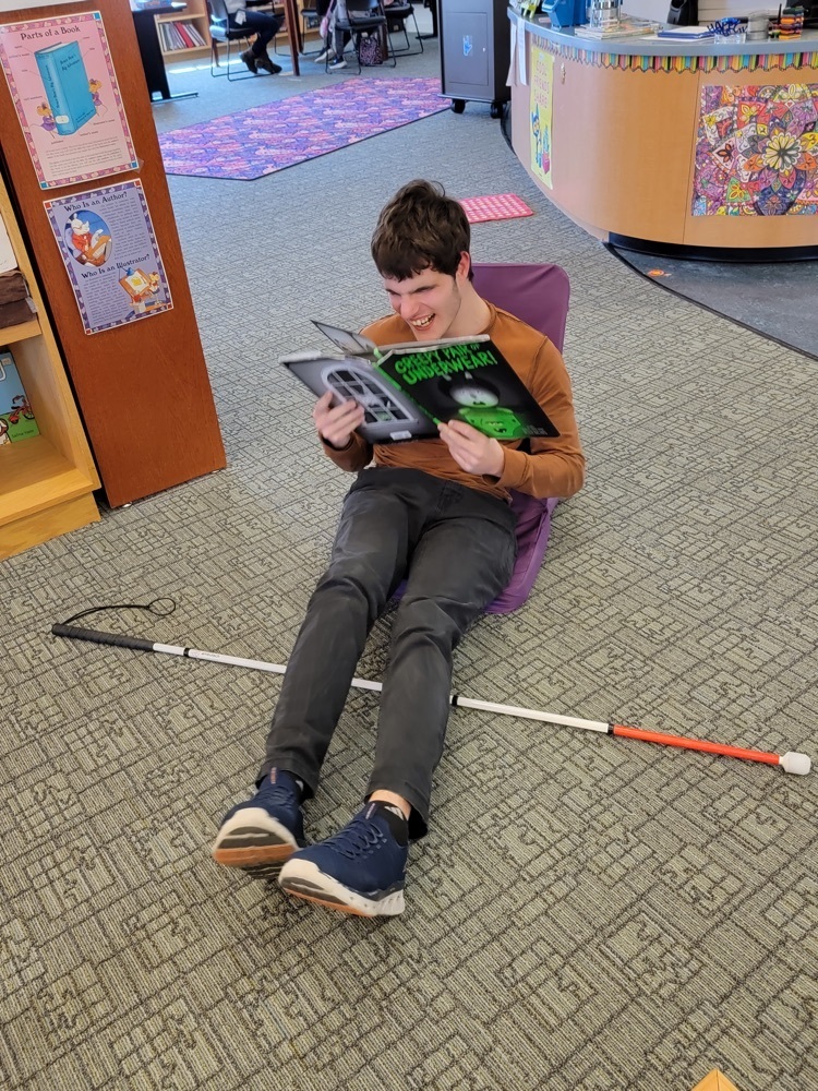 one male student reading a book 