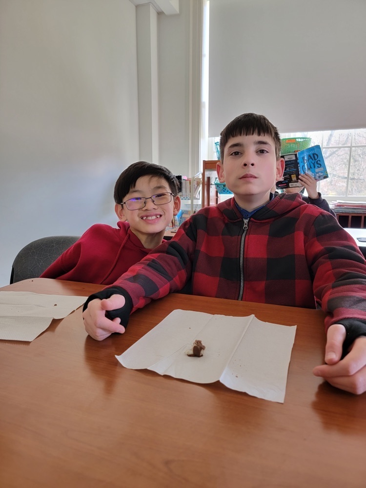 two male students eating Candy 