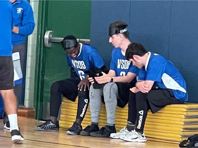 Jacob, Nikita, and Morris sitting on a bench and talking